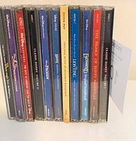 Row of 11 CD spines showing titles such as Frozen, Brave, Peter Pan, Lion King, Enchanted, The Prince of Egypt Nashville