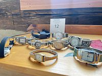 Group shot of all timepieces on wooden surface