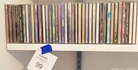 Front view of full shelf row showing breadth of CD lot
