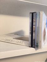 Side view showing four jewel cases and boxed title