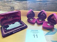 All four pendants in their respective velvet boxes