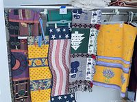 Overview of five textiles hanging on rod