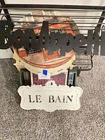 Group shot showing Bon Appétit sign, Le Bain plaque, round tray, stamps partially visible