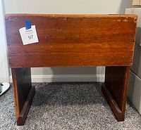 Front view of wooden shelf cabinet showing overall form and finish