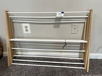 Front view showing full rack with six metal rods and wood sides