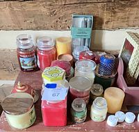 Group view of assorted candles on wooden shelf