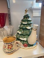Christmas tree teapot and floral creamer visible side by side