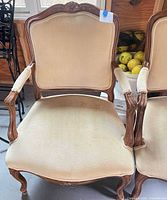 Front view of first fauteuil armchair showing overall design, upholstery and wood frame