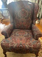 Front view of paisley upholstered wingback armchair