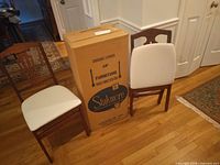 Two Stakmore folding chairs and original box