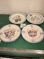 Group shot of four decorative plates on table