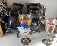 Front view showing two pitchers and two goblets