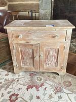 Front view showing drawer, doors, knobs and distressed finish