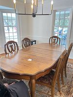 Dining table with four chairs around, showing overall style and wood finish