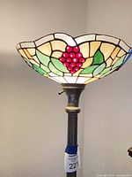 Close view of stained glass torchiere shade showing grape motif