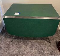 Front view showing green drop-leaf table with leaves down