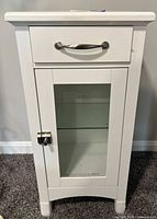Front view showing drawer, handle, glass door and latch