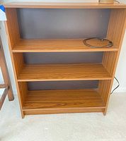 Front view showing entire bookcase, shelves, finish and back panel