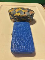 Jewelry box closed beside wallet