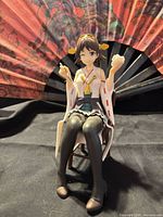 Front view of Hiei figure seated with teacup and snack