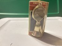 Front of boxed Casino Queen souvenir bell showing medallion and packaging