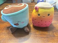 Front view of both plush toys together