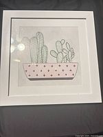 Front view of framed cactus illustration