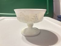 Side view of milk glass sherbet showing Harvest grape pattern