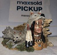 Front view of resin shaman figurine with wolf headdress and three wolves