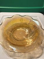 Top view of ruffled iridescent marigold glass bowl showing interior and color