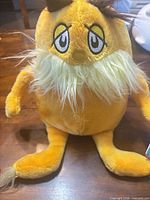 Front view showing full Lorax plush, facial features, limbs, overall condition