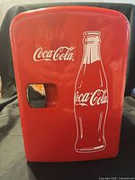 Front view showing Coca-Cola graphics and latch