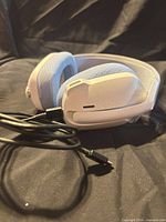 Headset laid flat with attached USB-C cable visible