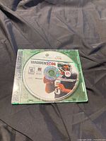 Front view of Madden NFL 06 disc in green case