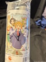 Rolled wall scroll in clear packaging showing character artwork and label