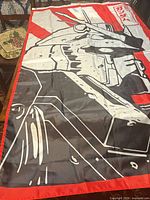 Full view of flag showing RX-78-2 graphic and red sun motif