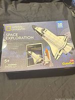 Front of box showing National Geographic Space Exploration 3D Puzzle, shuttle image, age rating