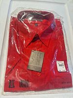 Front view of sealed package showing red shirt, original tag, JCPenney sticker