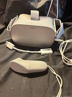Front view of Oculus Go headset with controller, cable, adapter visible