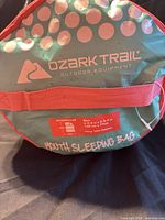 Front view of stuff sack showing Ozark Trail branding and youth sleeping bag label