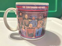 Left side of mug showing bridge crew graphic and Continuing Voyages text