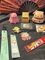 Group shot of all items including fan, music box, figures and keychains