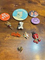 Full group of ten pins and buttons on wood surface