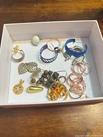 Full view of box containing assorted jewelry pieces