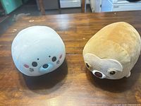 Front view of spherical sloth plush (seal plush also visible but not part of lot)