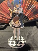Front view of Rem figure on checkered base