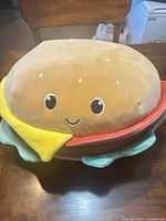 Front view of Carl the Cheeseburger showing face and layers