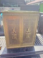 Front view of faux-bamboo Chinoiserie cabinet with cane panels and Chinese characters