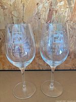 Front view of both crystal red wine glasses showing etched Sterling Vineyards logo