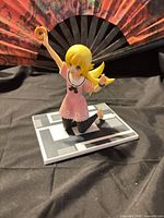 Front view of Shinobu Oshino figure on base, donut raised